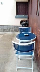a blue and white chair sitting next to a building at coin tranquille in Pont-du-Château +5 photos