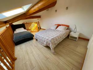 a bedroom with two beds in a attic at Appartement Cosy avec extérieur au calme in Rocbaron