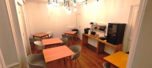 a room with tables and chairs and a tv at KastellRen - Rennes - Grand parking privé in Rennes