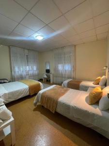 Postel nebo postele na pokoji v ubytování Hostal Real