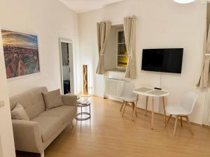 a living room with a couch and a table at Ferienwohnung Schildblick Modernes Apartment direkt in der Altstadt von Erfurt nahe der Krämerbrücke - beste Innenstadtlage in Erfurt