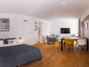a bedroom with a bed and a table and chairs at Le Cornouaille Hotel & Spa in Bénodet