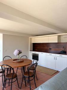 a kitchen with a wooden table and chairs at Casa da Eira Country House in Vila do Conde