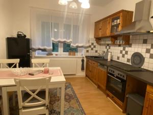 a kitchen with a table and a stove top oven at Pension Gut Runge in Kiebitz