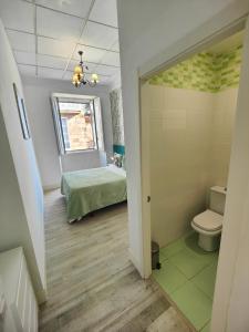 a small bathroom with a bed and a toilet at RUA NOVA APARTMENT, 3 Dormitorios, PS4 y Netflix, a 200m Catedral in Santiago de Compostela +64 photos