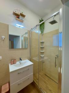 a bathroom with a sink and a shower at Apartman Vasanija in Opatija +14 photos