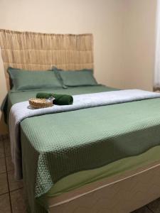 a green bed with a stuffed animal on top of it at Hostel Wei in Boa Vista +34 photos