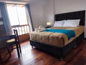 A bed or beds in a room at Anata Hotel