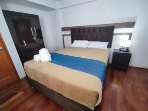 A bed or beds in a room at Anata Hotel