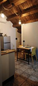 a kitchen with a table and a refrigerator and a table at Ca' Libellula Casa Vacanza in Avola +39 photos