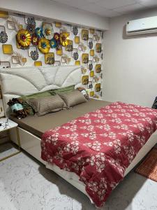 a bed in a room with a wall with pictures at Couple Love Condos 1BHK in Zirakpur