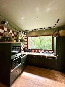 a kitchen with a sink and a window in it at LA FEUILLÉE, Charmante Maison au Bois de Cise in Ault +34 photos