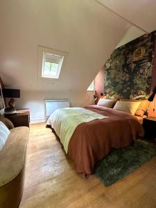 a bedroom with a large bed and a window at LA FEUILLÉE, Charmante Maison au Bois de Cise in Ault