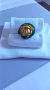 a pile of towels with a rose on them at B&B Central Station in Palermo +44 photos