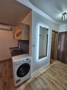 a washer and dryer in a room with a kitchen at Apartmán v centre mesta Levice in Levice +3 photos