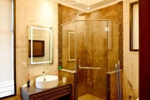 a bathroom with a shower with a sink and a sink at Luxury Spanish Villa Close to Raya Fairways Commercial in Lahore +58 photos