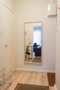 a mirror on the wall of a room with a living room at GuestFirst- Modern Boho Charm in Kallio Helsinki Center in Helsinki +33 photos