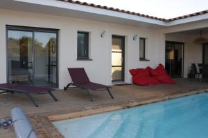 a patio with two chairs and a swimming pool at Villa Augusta pour 10 personnes - 4 étoiles in Villevieille