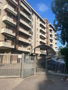 a gate in front of a large apartment building at La Casa per te in Pescara +17 photos