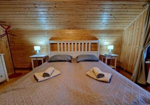 a bedroom with a large bed with two pillows on it at Casa Emmara Sighisoara in Sighişoara
