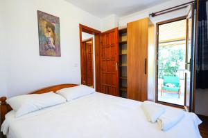 a bedroom with a bed and a window and a chair at Villa Misli - red/ green in Dalyan +35 photos