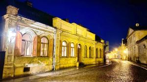 an old building on a city street at night at B19 Kuldiga in Kuldīga