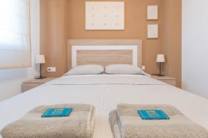 a bedroom with a large bed with two blue plates on it at Blue Marine in Peniscola