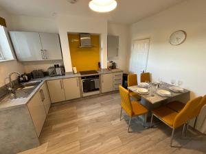 a kitchen and dining room with a table and chairs at Star Road Home, central location, FREE parking in Peterborough +23 photos
