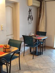 a dining room with a table and chairs and a horse on the wall at Les Geckos in Saintes-Maries-de-la-Mer