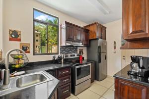 a kitchen with stainless steel appliances and a window at Villa with Pool, Gated Playas del Coco Getaway in Coco