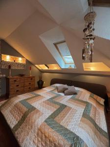 a bedroom with a large bed in a attic at Exclusive Golden Sands apartment in Rīga +35 photos