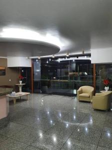 a lobby with a couch and chairs in a building at Golden Gate Residence Service in Vitória +51 photos