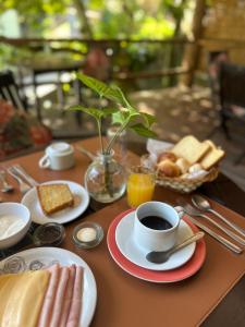 a table topped with a cup of coffee and toast at Pousada Mariola in Ilhabela