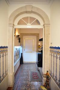 a room with a large white door and a large white rug at Portfolio Guest House in Porto