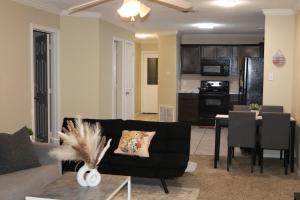 a living room with a couch and a dining room at Lubbock haven Rooms with individual Bathrooms in Lubbock