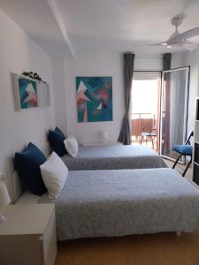 ジローナにあるCENTRICO y ACOGEDOR APARTAMENTOのベッド2台とソファのある寝室