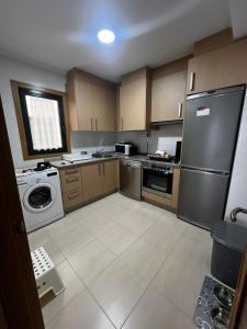 a kitchen with a stainless steel refrigerator and a dishwasher at Duplex Playa de Foz in Foz