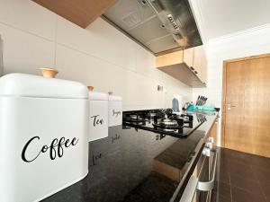 a kitchen with a white coffee appliance on the wall at Rooms for Rent Residence Funchal in Funchal