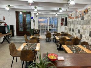 a restaurant with tables and chairs and a room with windows at Vilador Beach Hotel in El Masnou