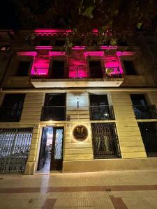 a building with pink lights on the side of it at Vilador Barcelona Beach Hotel in Masnou