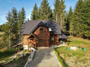 an image of a log cabin in the woods at Vacation Home Miki 2 in Ljuboš
