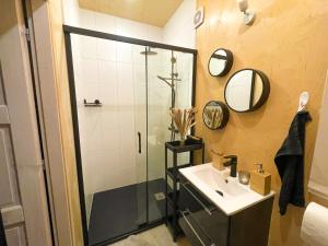 a bathroom with a sink and a shower at Tiny house u řeky - Bouda Krušnohorka in Vojkovice