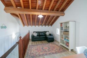a living room with a couch and a book shelf at Maria's Haven in Santo António