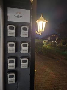 a pay telephone booth with a light on a street at BerlinDreams in Berlin