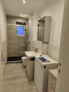 a bathroom with a shower and a sink and a toilet at BerlinDreams in Berlin