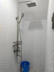 a shower with a shower head in a bathroom at Casa Bugambilia Downstairs Unit in Balamban