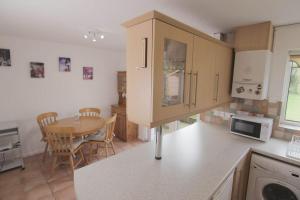 a kitchen with a table and a dining room at 2 Bed House - BHX - NEC in Solihull