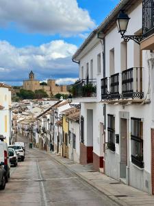 a city street with buildings and cars parked on the street at Apartamento Turístico Centro Antequera B in Antequera
