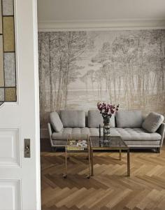 a living room with a couch and a table at Appartement de style 70 in Colmar