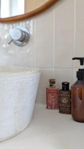 a bathroom counter with a sink and a mirror at Casa Caiada in Beja +13 photos
